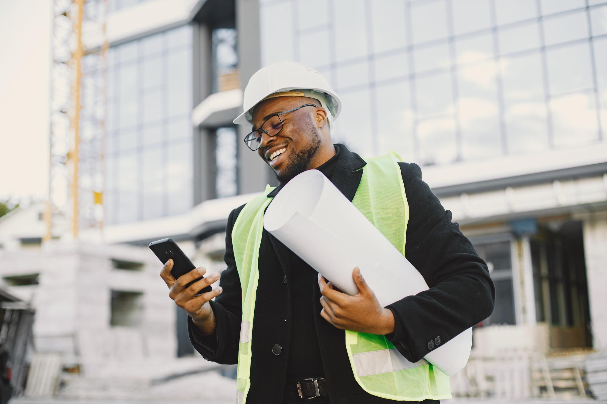 Construction professional reviewing plans at a building site